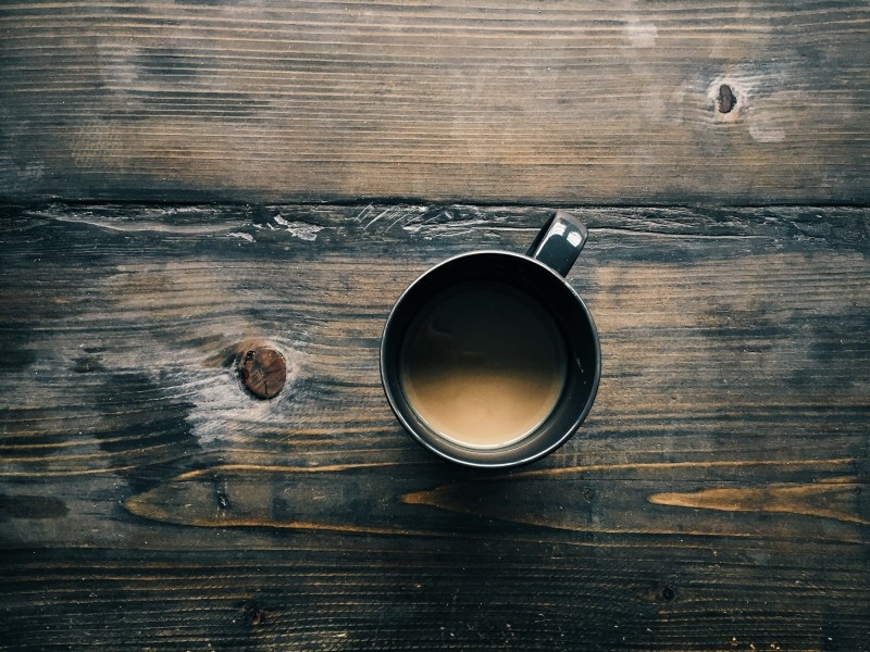 aerial-view-of-coffee-cup-on-wooden-table